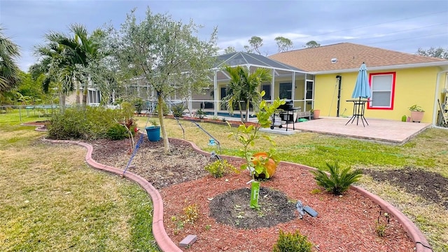 view of yard with glass enclosure and a patio area