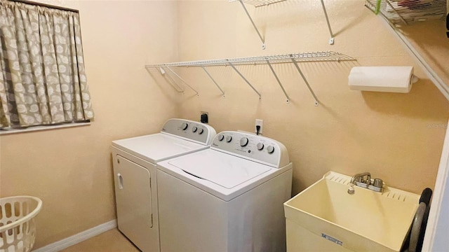 laundry area featuring sink and washing machine and dryer