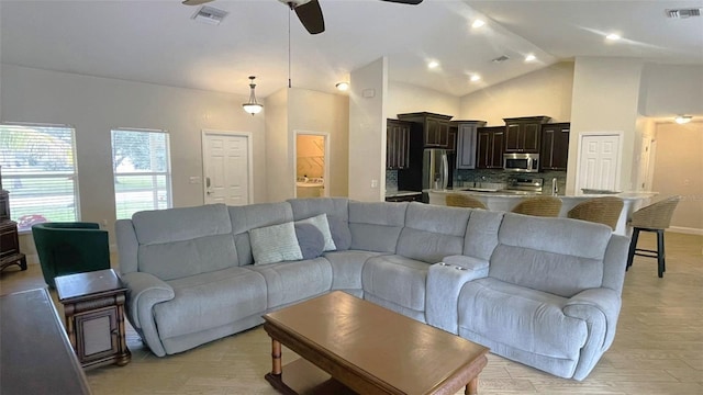 living room featuring lofted ceiling, light hardwood / wood-style flooring, and ceiling fan