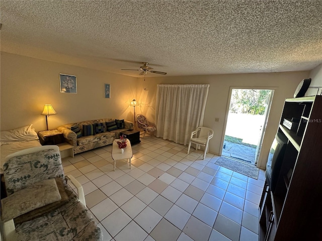 tiled living room featuring ceiling fan and a textured ceiling