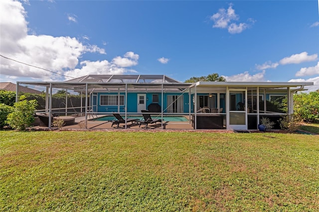 back of house with a patio, glass enclosure, and a yard