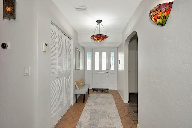 doorway with light tile patterned floors