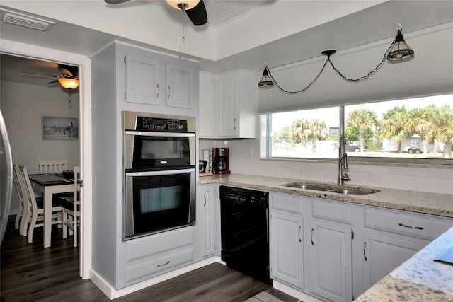 kitchen featuring black dishwasher, stainless steel double oven, white cabinets, sink, and backsplash