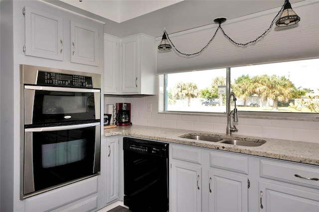 kitchen featuring dishwasher, stainless steel double oven, decorative backsplash, sink, and white cabinets