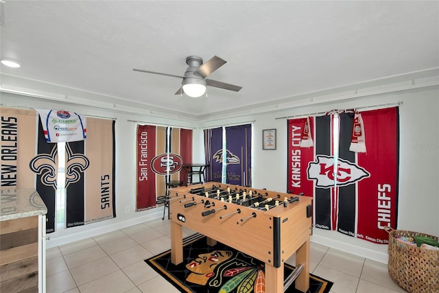 recreation room with ceiling fan and tile patterned flooring