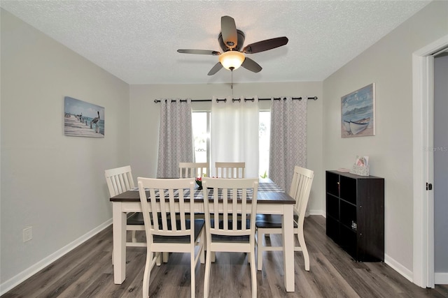 dining area with a textured ceiling, dark hardwood / wood-style floors, and ceiling fan