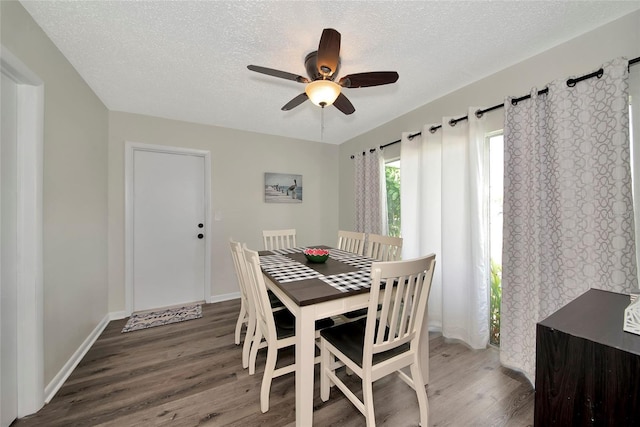 dining space with ceiling fan, a textured ceiling, and dark hardwood / wood-style flooring