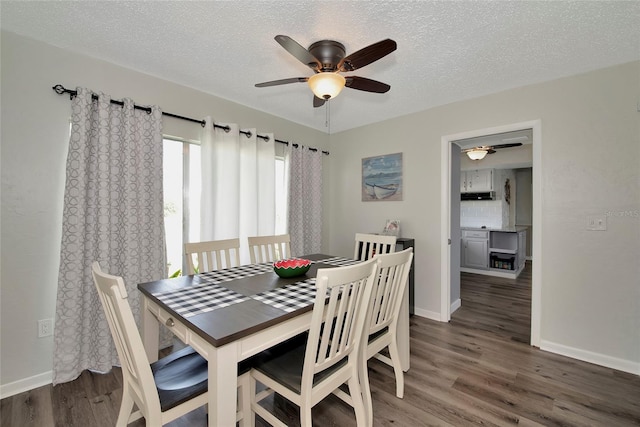 dining room featuring ceiling fan, dark hardwood / wood-style floors, and a textured ceiling