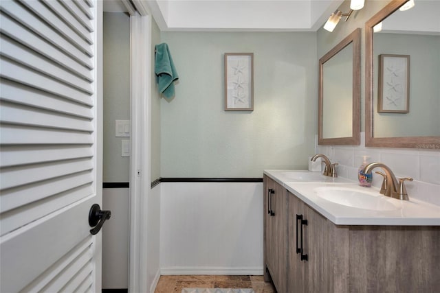 bathroom with vanity and backsplash