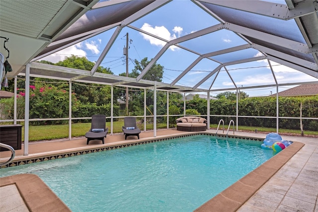 view of pool with a patio area and a lanai