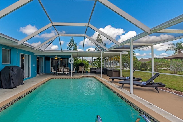 view of swimming pool featuring glass enclosure, outdoor lounge area, a grill, and a patio