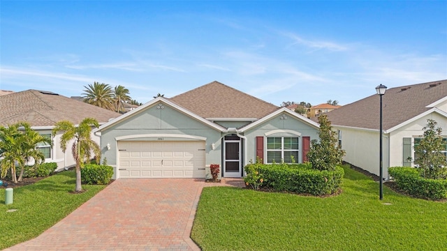 ranch-style home with a garage and a front lawn