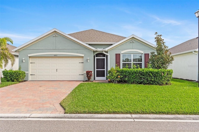 ranch-style house with a garage and a front yard