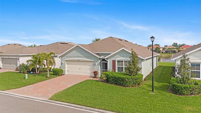 single story home with a garage and a front lawn