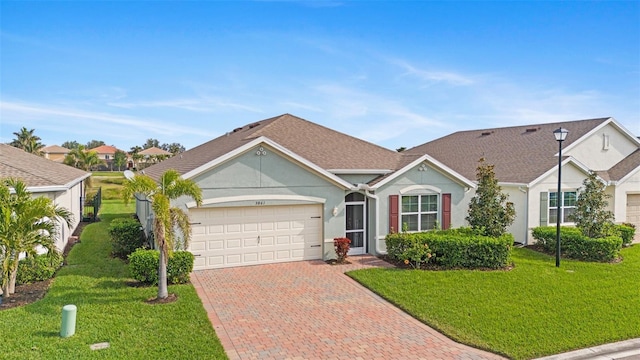 ranch-style home featuring a garage and a front lawn