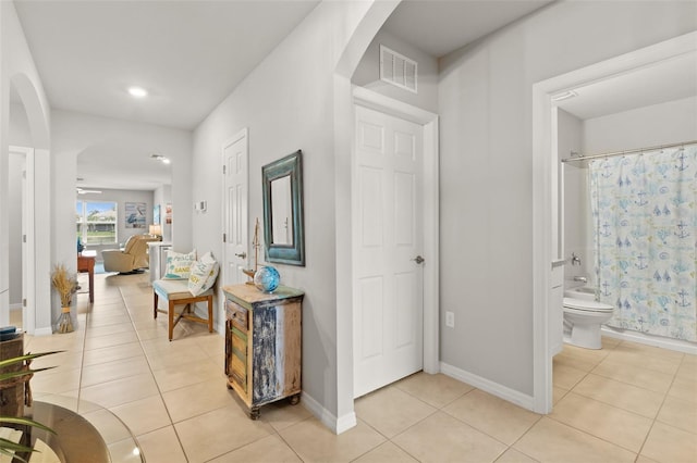 hall with light tile patterned flooring