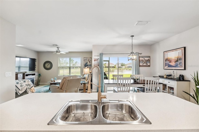 kitchen with sink, ceiling fan, and pendant lighting