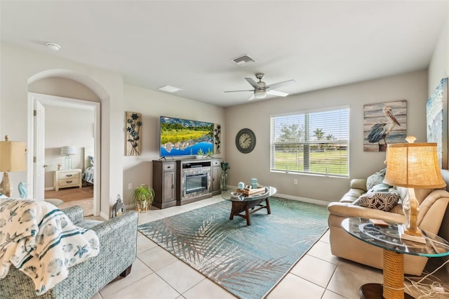 tiled living room featuring ceiling fan