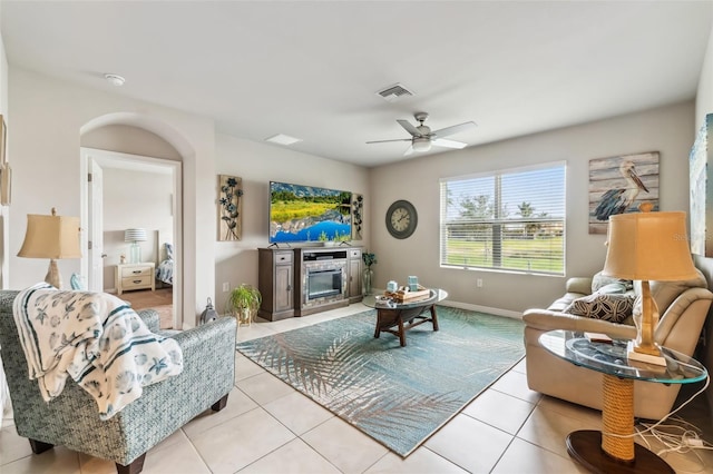 tiled living room featuring ceiling fan