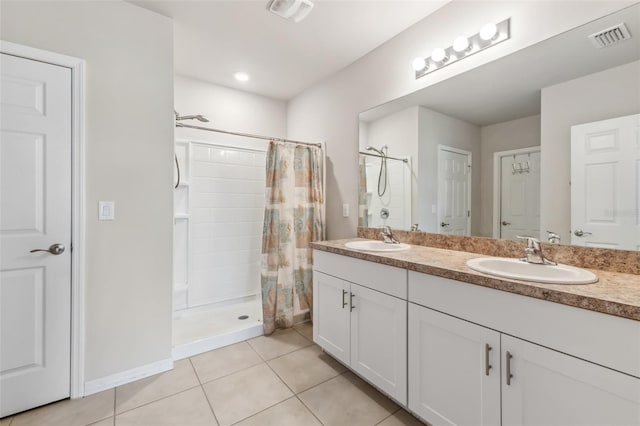 bathroom featuring walk in shower, vanity, and tile patterned flooring