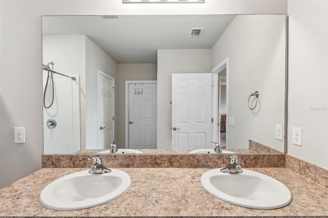 bathroom with walk in shower and vanity