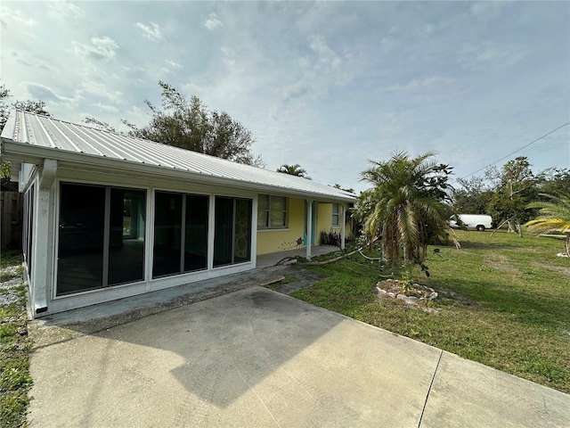 rear view of house with a patio area and a yard