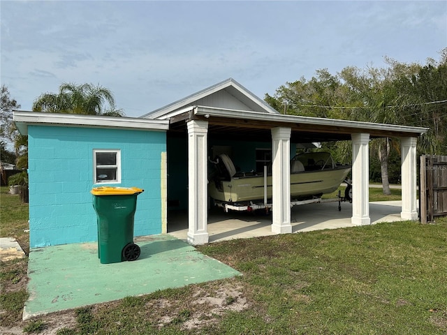 exterior space with a lawn and a carport