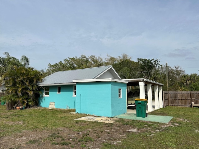 view of side of home with a yard