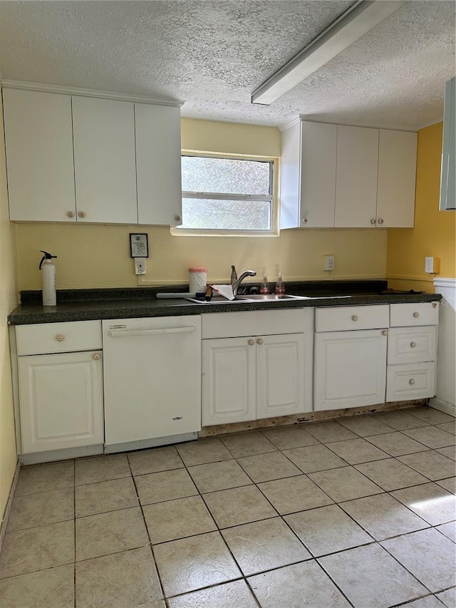 kitchen featuring sink, white cabinets, white dishwasher, and a textured ceiling