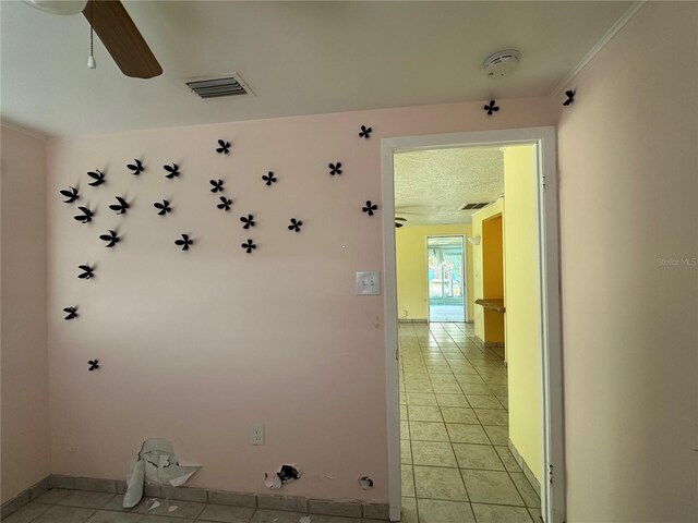 interior space featuring a textured ceiling, ceiling fan, and ornamental molding