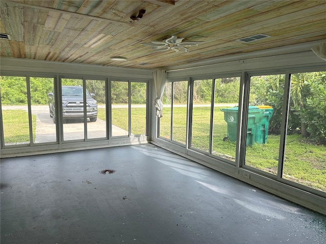 unfurnished sunroom with wooden ceiling and ceiling fan