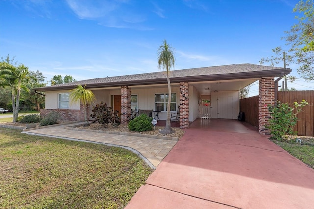 ranch-style house with a front yard and a carport