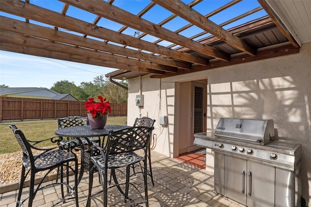 view of patio with grilling area and a pergola