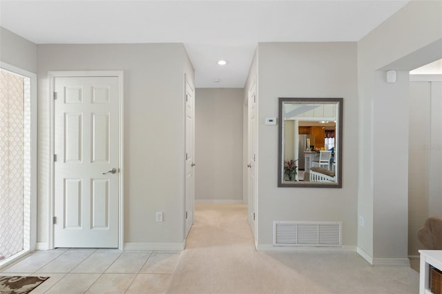 hallway featuring light tile patterned flooring