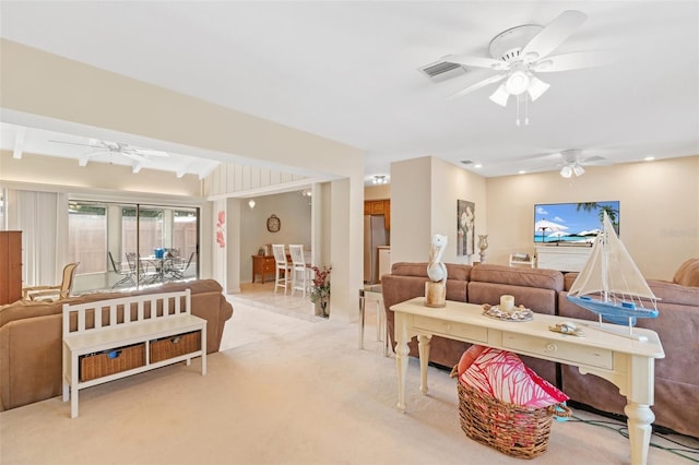 carpeted living room with ceiling fan