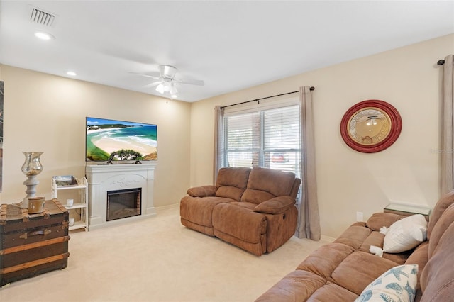 carpeted living room featuring ceiling fan