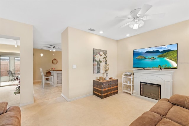 living room featuring ceiling fan and light colored carpet