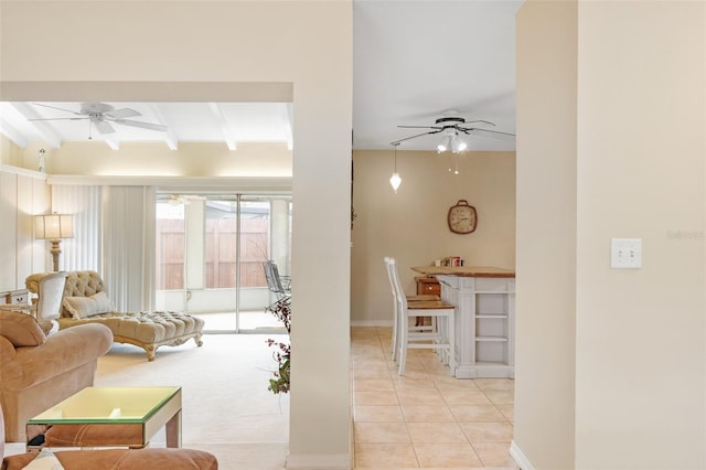 tiled living room featuring beamed ceiling and ceiling fan