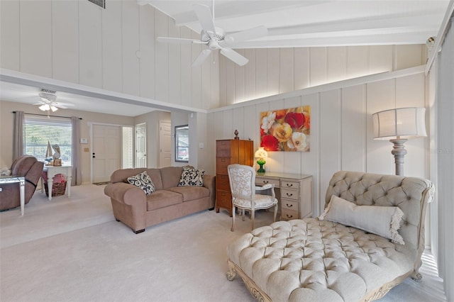 carpeted living room featuring ceiling fan and beamed ceiling