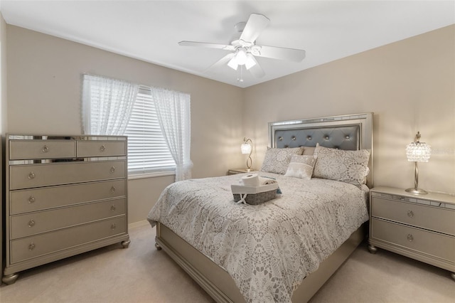 bedroom with light carpet and ceiling fan