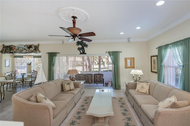 living room featuring light tile patterned floors, ornamental molding, and ceiling fan