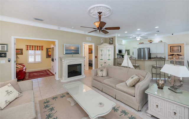 tiled living room featuring ornamental molding and ceiling fan