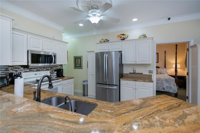 kitchen featuring white cabinetry, decorative backsplash, and appliances with stainless steel finishes