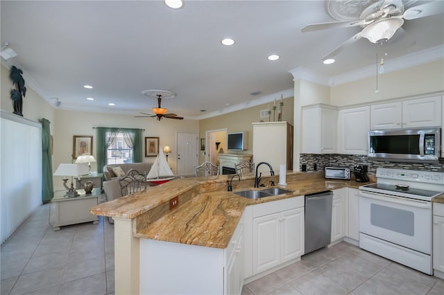 kitchen featuring white cabinetry, appliances with stainless steel finishes, sink, and kitchen peninsula