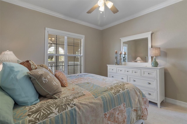 carpeted bedroom featuring ceiling fan and ornamental molding