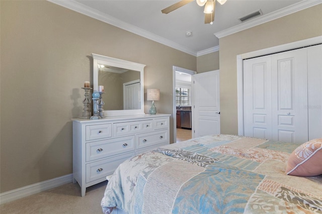 carpeted bedroom featuring ceiling fan, a closet, and ornamental molding