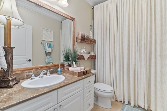 bathroom featuring tile patterned floors, vanity, ornamental molding, and toilet