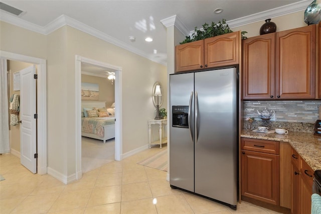 kitchen with tasteful backsplash, stainless steel fridge with ice dispenser, ornamental molding, light stone counters, and light tile patterned flooring