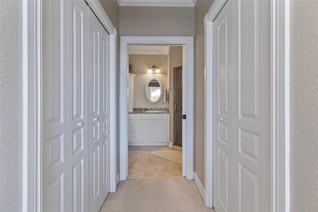 hall featuring light colored carpet and sink