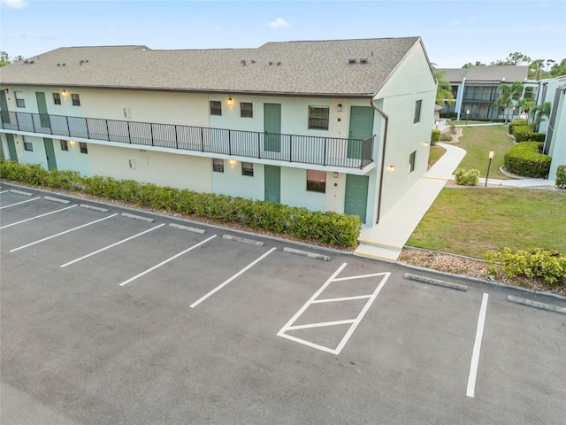 view of car parking featuring a yard